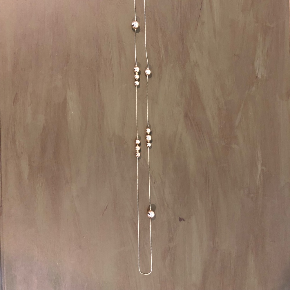 Long gold necklace with beads